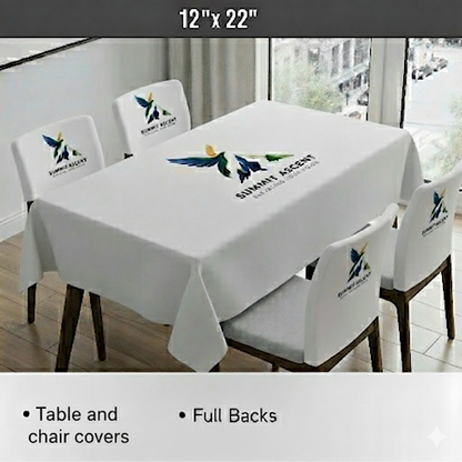 Personalized Dining table and chairs with branded tablecloth and chair covers in a room with large windows.