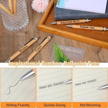 Inspirational bamboo ballpoint pens on a wooden surface with text and writing samples.