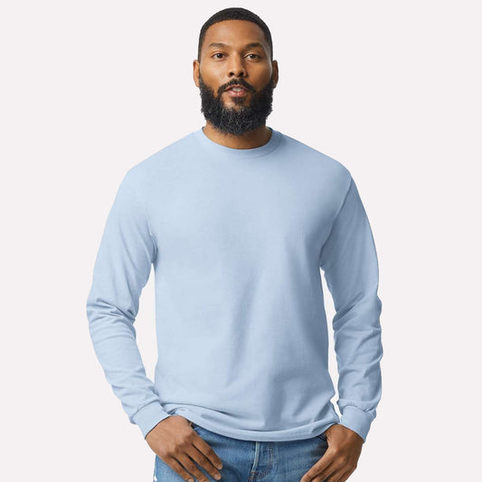 Man wearing a light blue long-sleeve shirt against a plain background - the t-shirt is personalized 