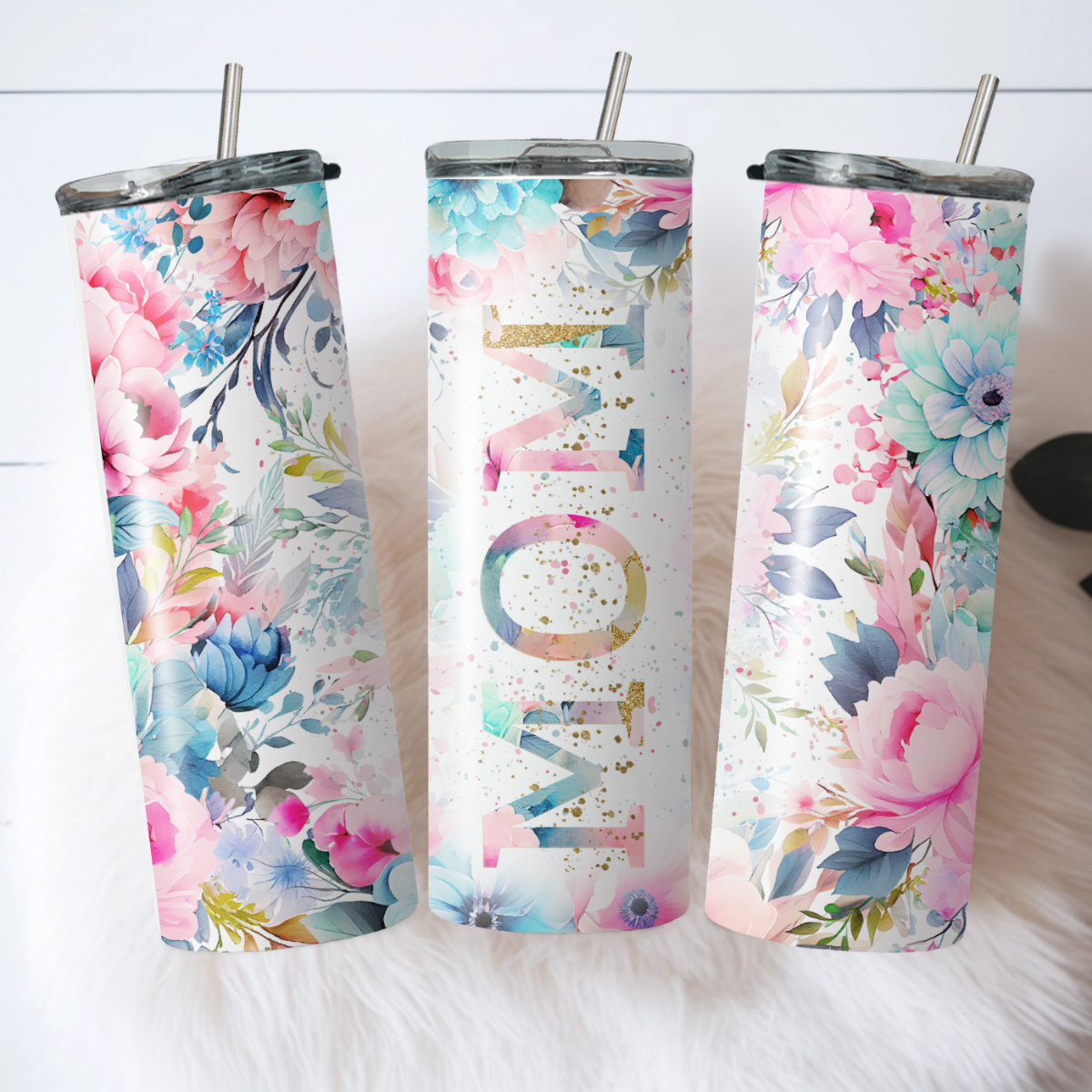 A set of three custom insulated travel cups with floral patterns and the word 'MOM' displayed prominently on the front.